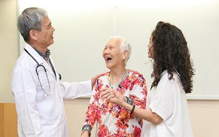 Photo of doctor talking with patient and family members